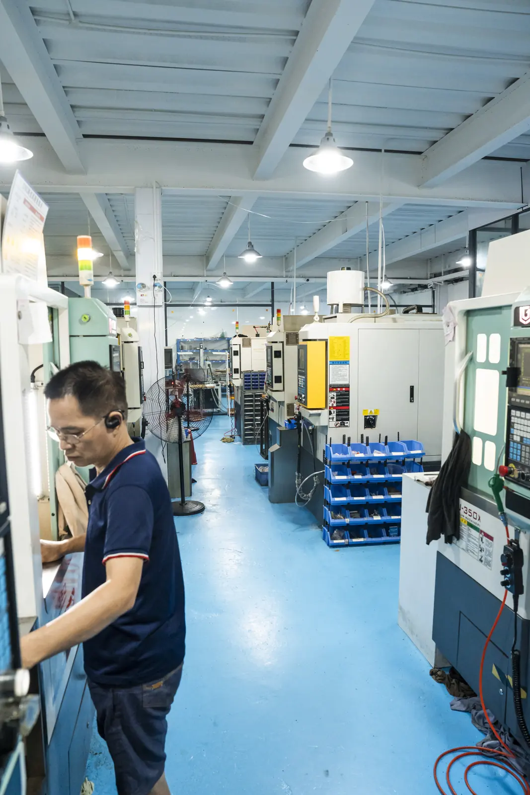 ORNOVAI operator working beside CNC machines
